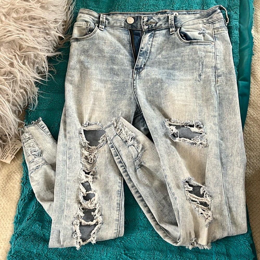 Distressed light blue jeans